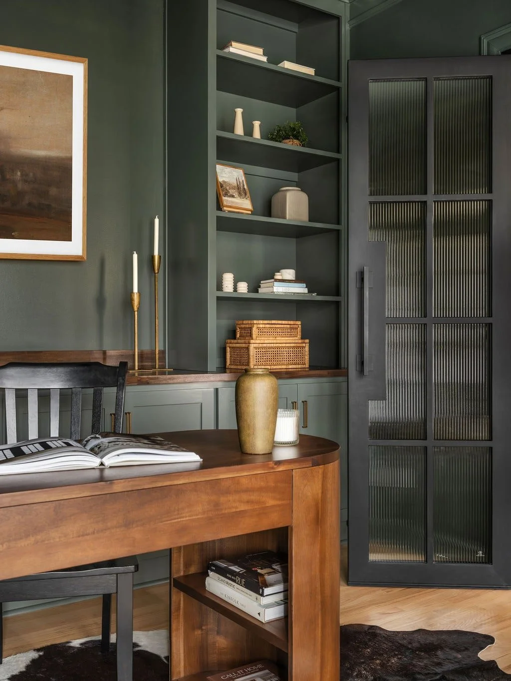 Masculine Home office with additional storage through built ins, walnut stained countertop, and a cowhide rug