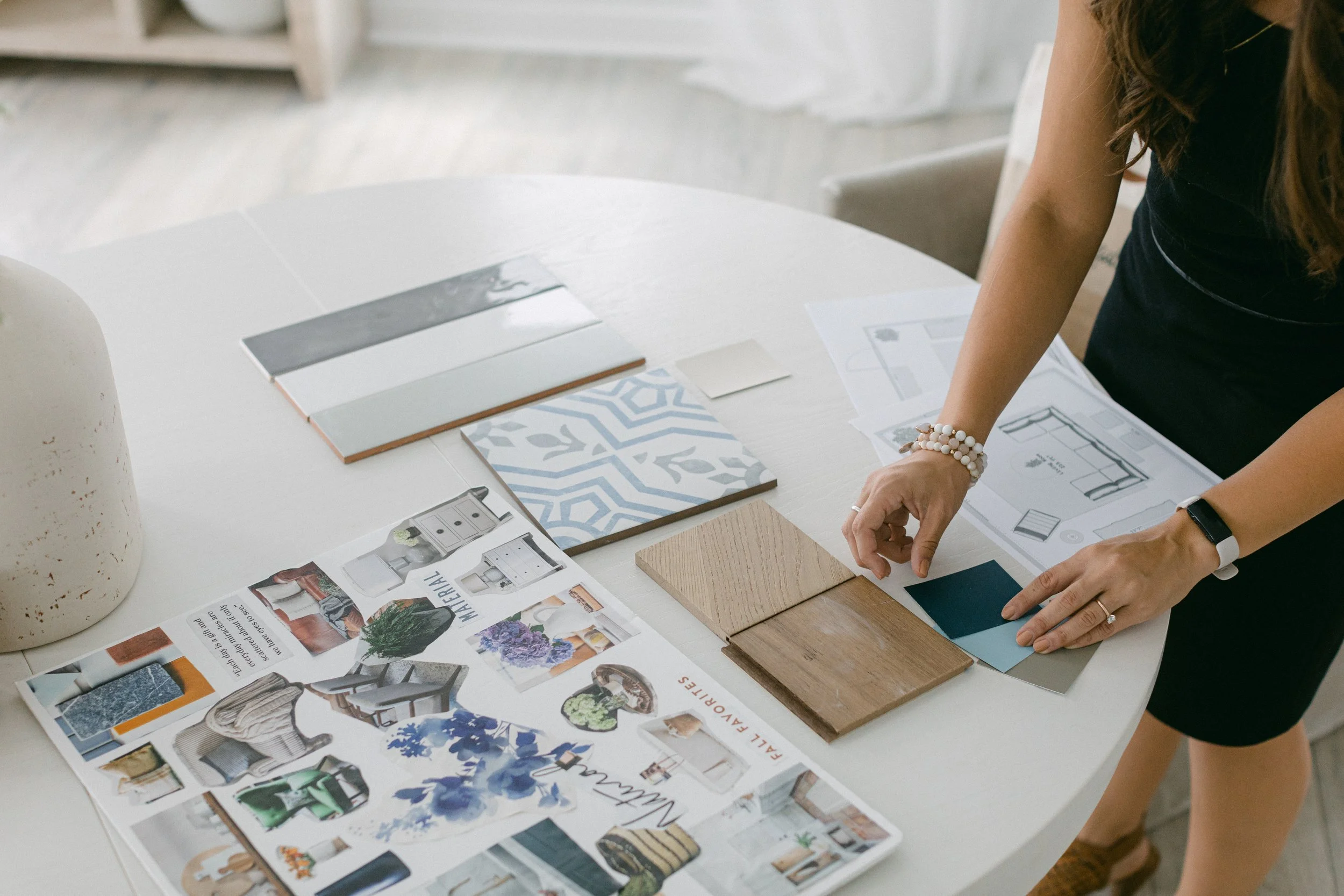 Interior Designer organizing materials on desk in Athens, GA studio