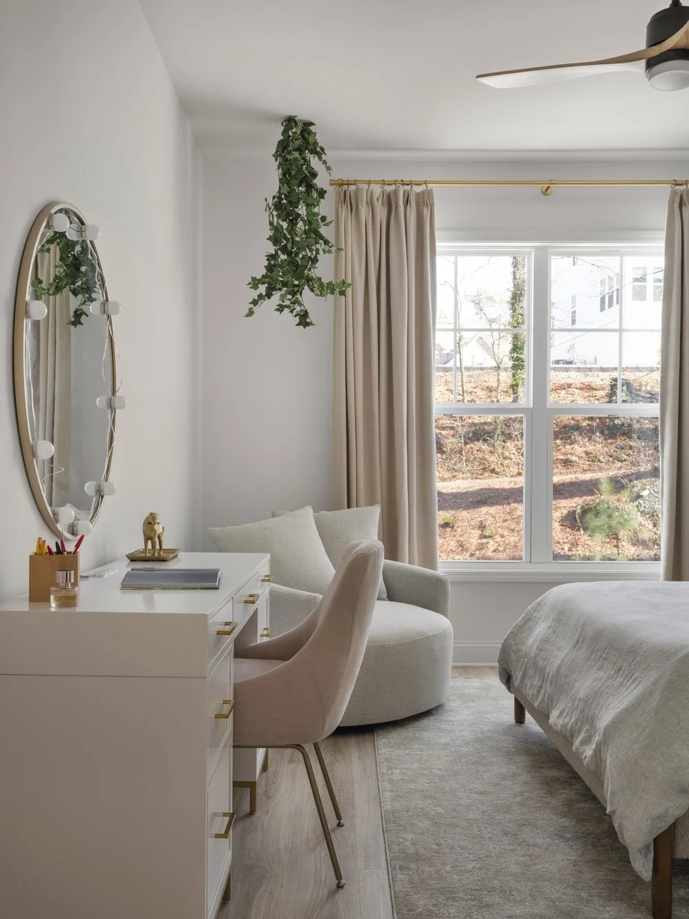 Teen Bedroom Designed with a getting ready area ant swivel chair in the corner for a reading nook. Neutrals and blush pink add character to this teenage bedroom