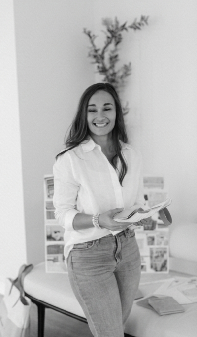 Interior Designer in HArtwell Smiling at camera while holding paint swatches