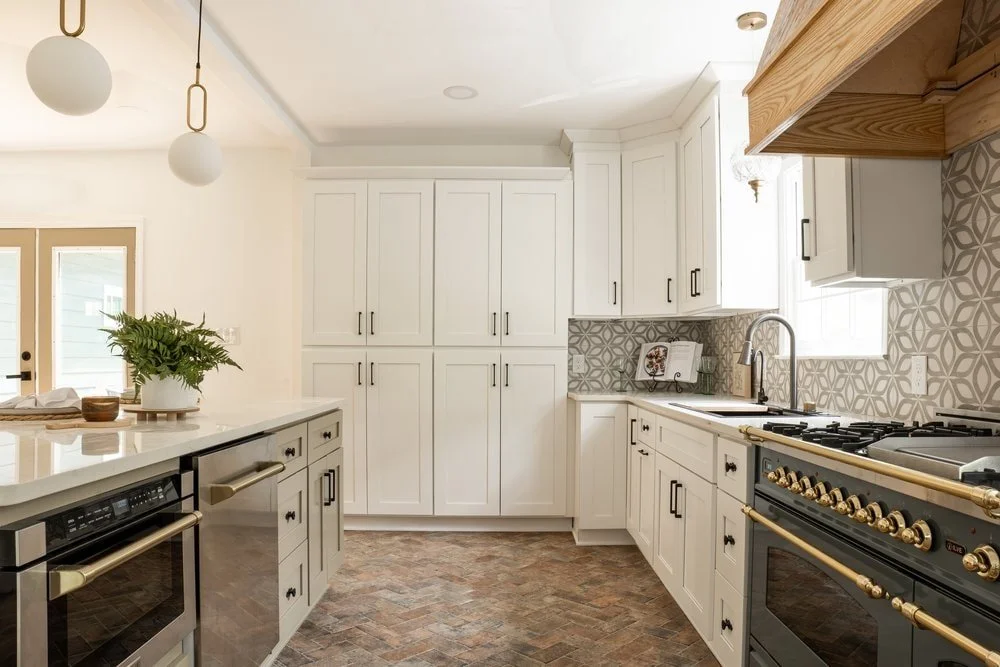 Luxury kitchen design in Georgia with stone floors and custom white kitchen cabinetry. modern Traditional kitchen design