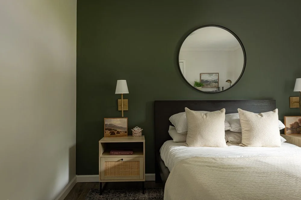 Modern transitional guest bedroom with SW Pewter Green Accent Wall, platform bed and brass wall sconces in Georgia home