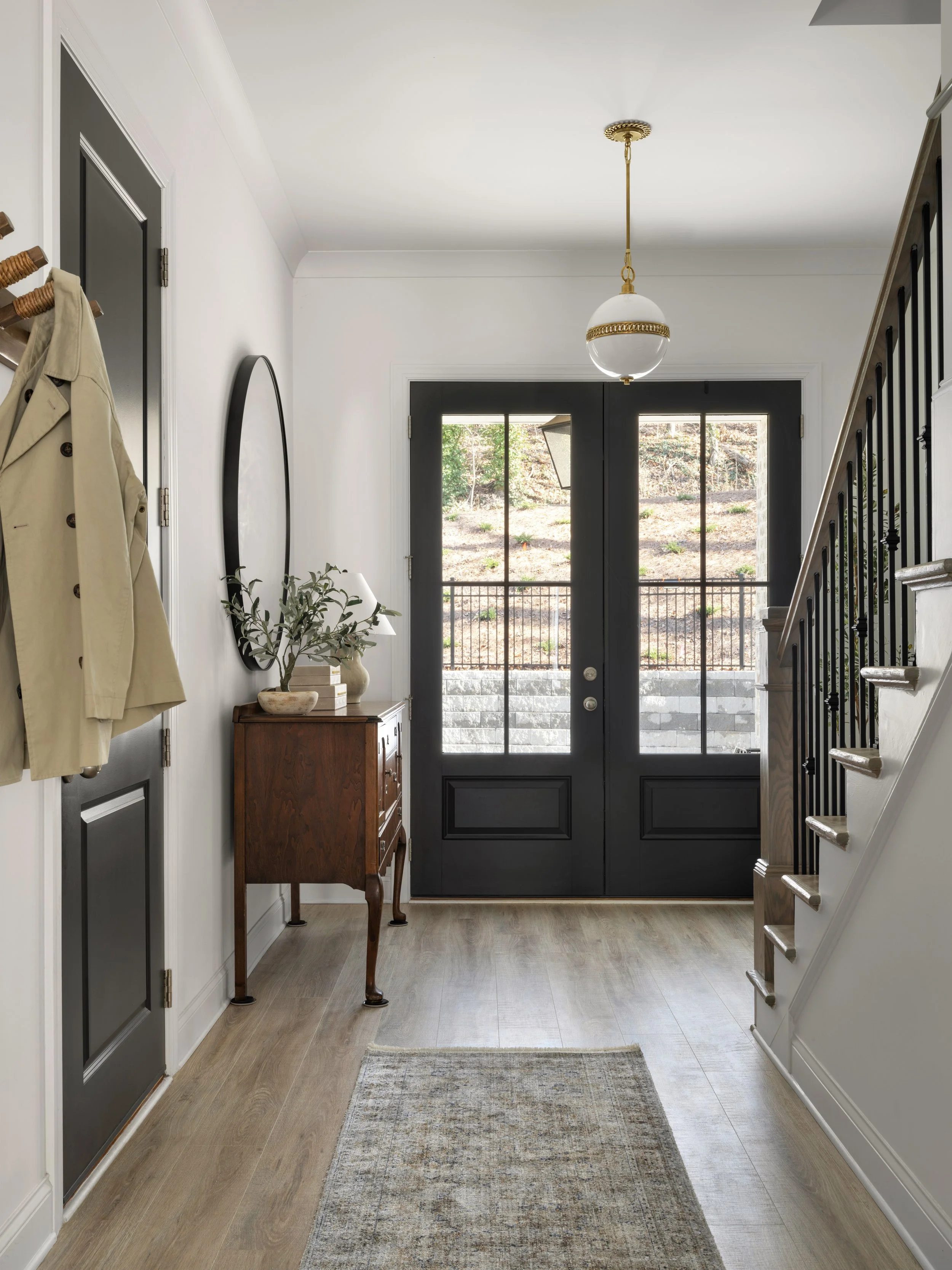 Modern Traditional Family Room in Marietta with double frendhc doors and traditional entry table