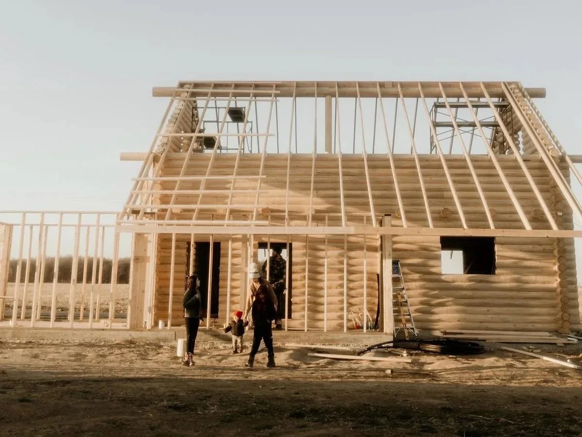 Family Outside their new home during framing