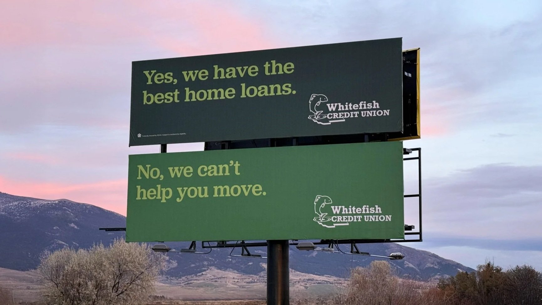 Stacked billboards for Whitefish Credit Union that read "Yes, we have the best home loans." and "No, we can't help you move."