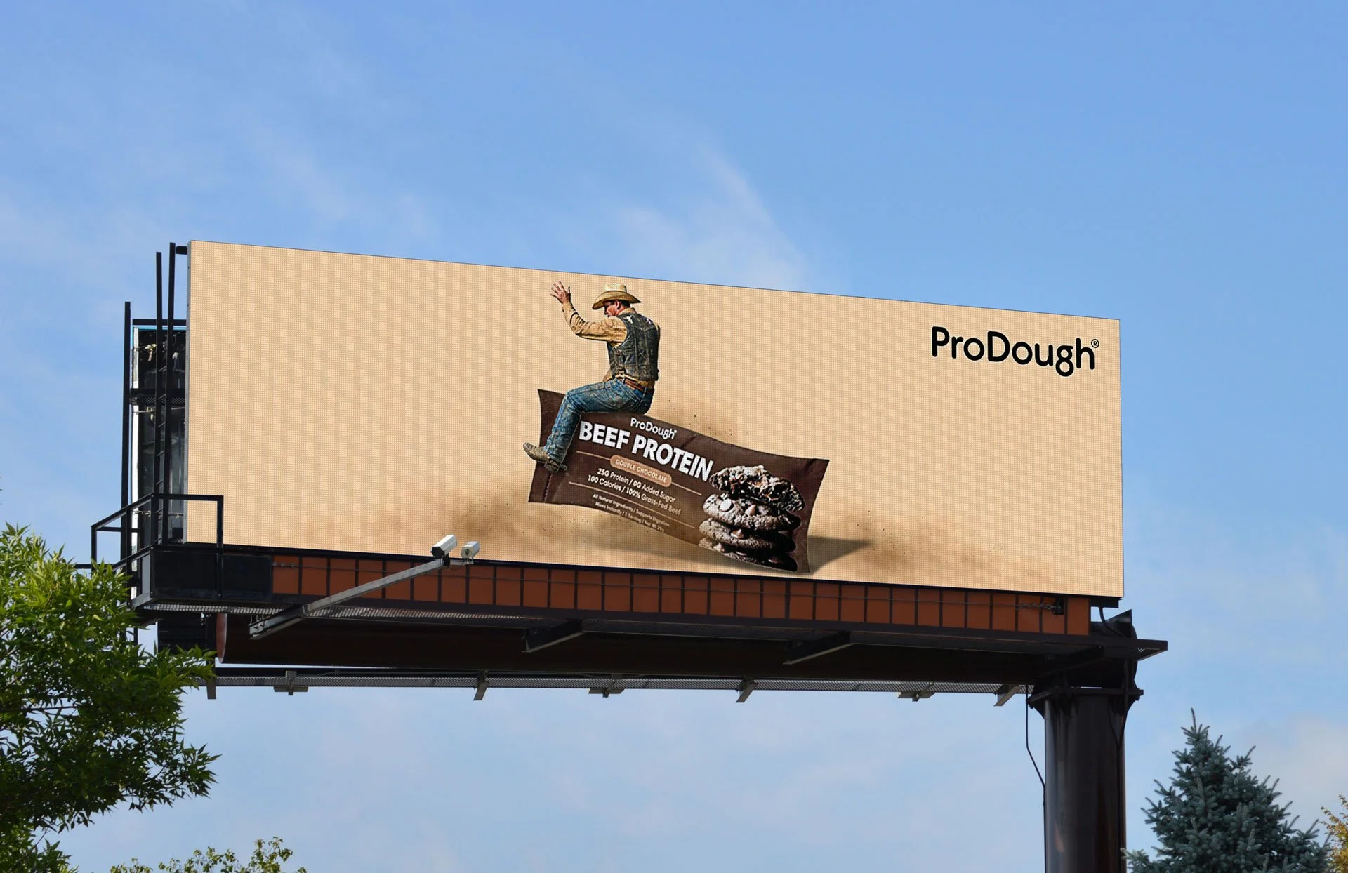 Bull rider on a ProDough Beef Protein packet on a tan digital billboard.