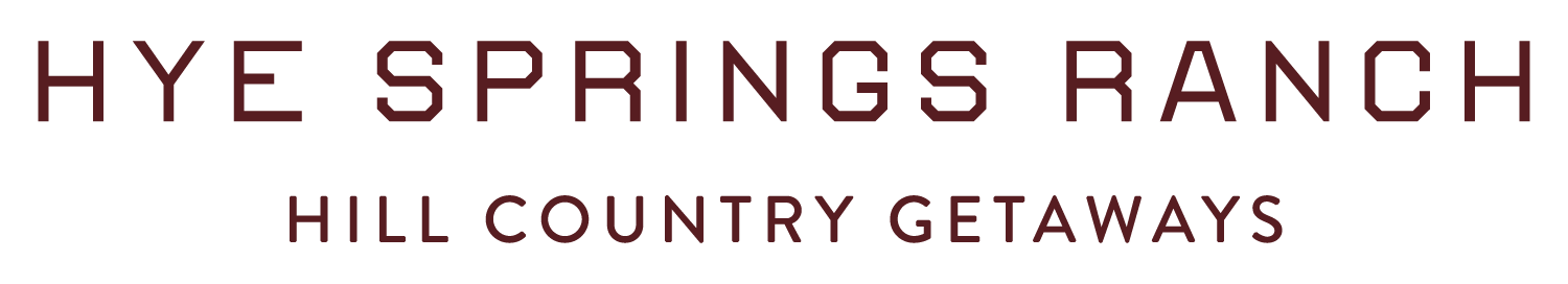 Hye Springs Ranch Hill Country Getaways sign in maroon text on white background