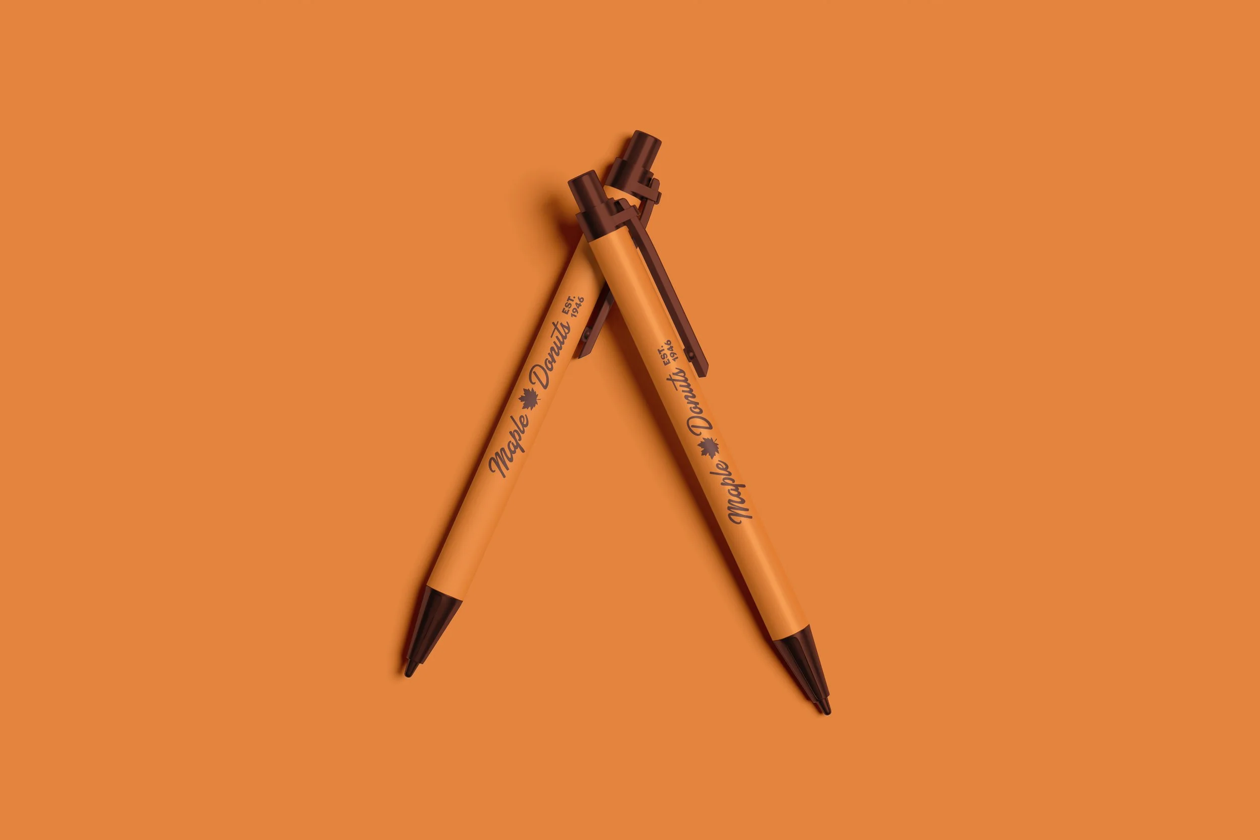 Maple Donuts branded orange pens