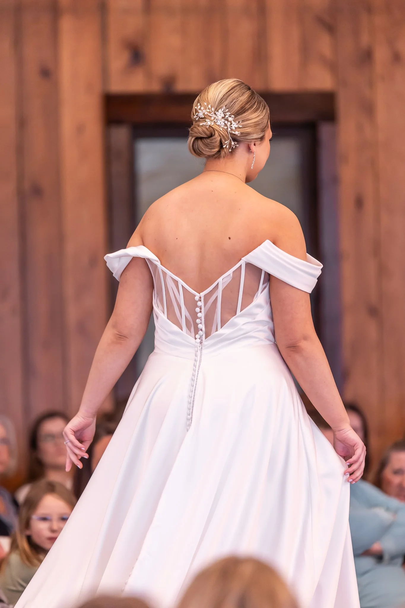Woman in a white wedding dress walking down the aisle at her wedding.