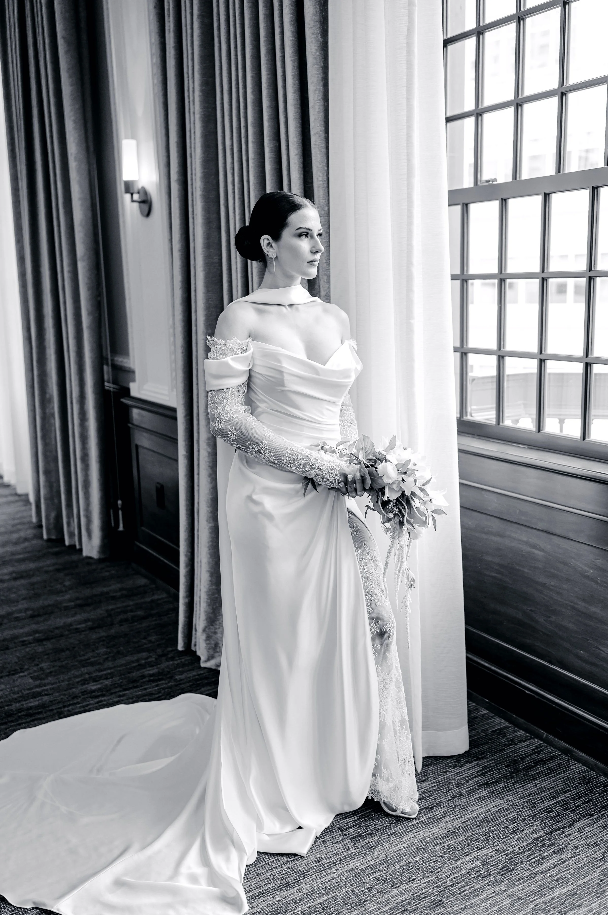 black and white picture of a bride with a sophia richie inspired bun styled by bespoke beauty llc an iowa bridal hairstylist