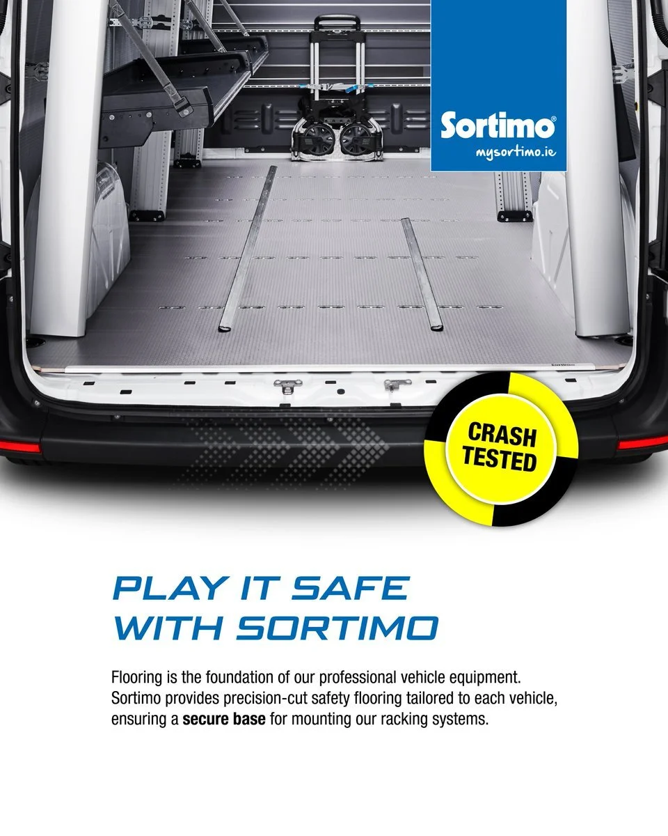 Interior of a cargo van showing flooring and safety equipment, with a blue Sortimo logo and a yellow circular badge that says 'Crash Tested,' promoting vehicle safety flooring.