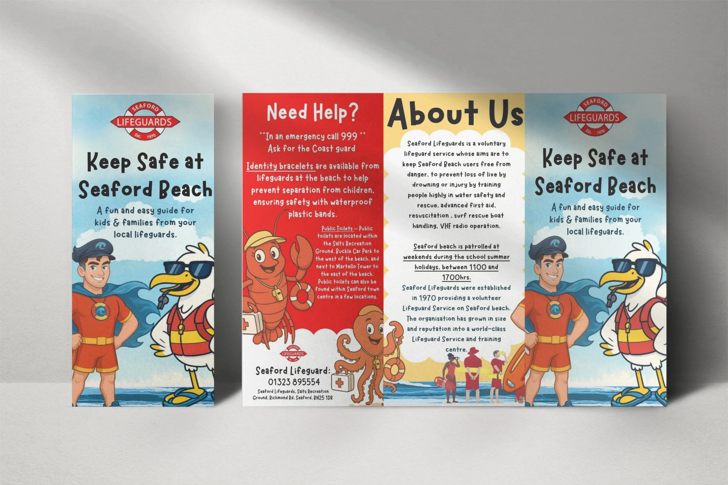 Triptych of informational leaflets about Seaford Lifeguards, with cartoon characters of a young male lifeguard and a seagull on the left and right panels, and a central panel providing emergency contact information, about Seaford Lifeguards, and statistics, featuring illustrations of lifeguards, a lobster, and swimmers on the beach.