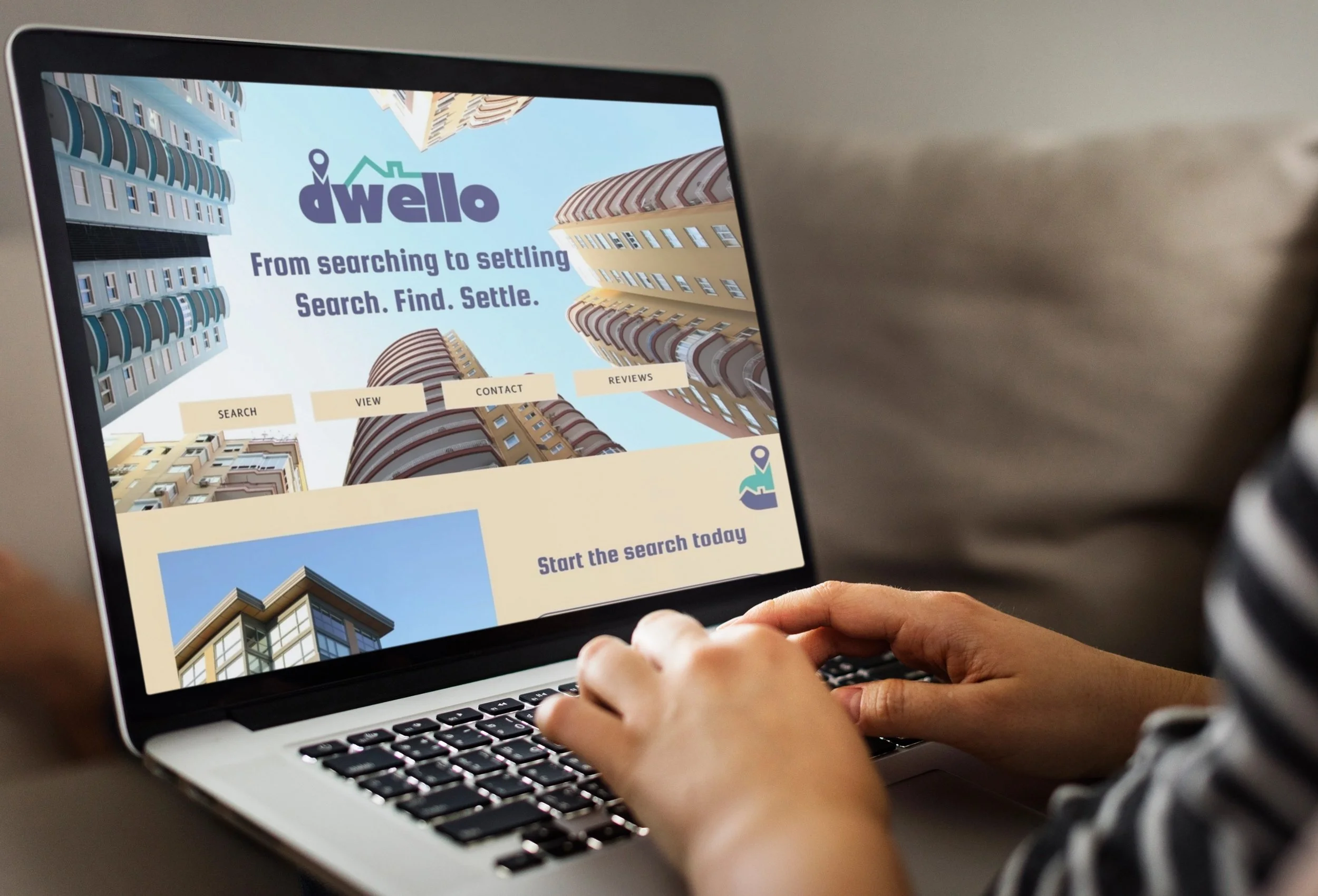 Person browsing a real estate website on a laptop, featuring skyscraper images and search options.