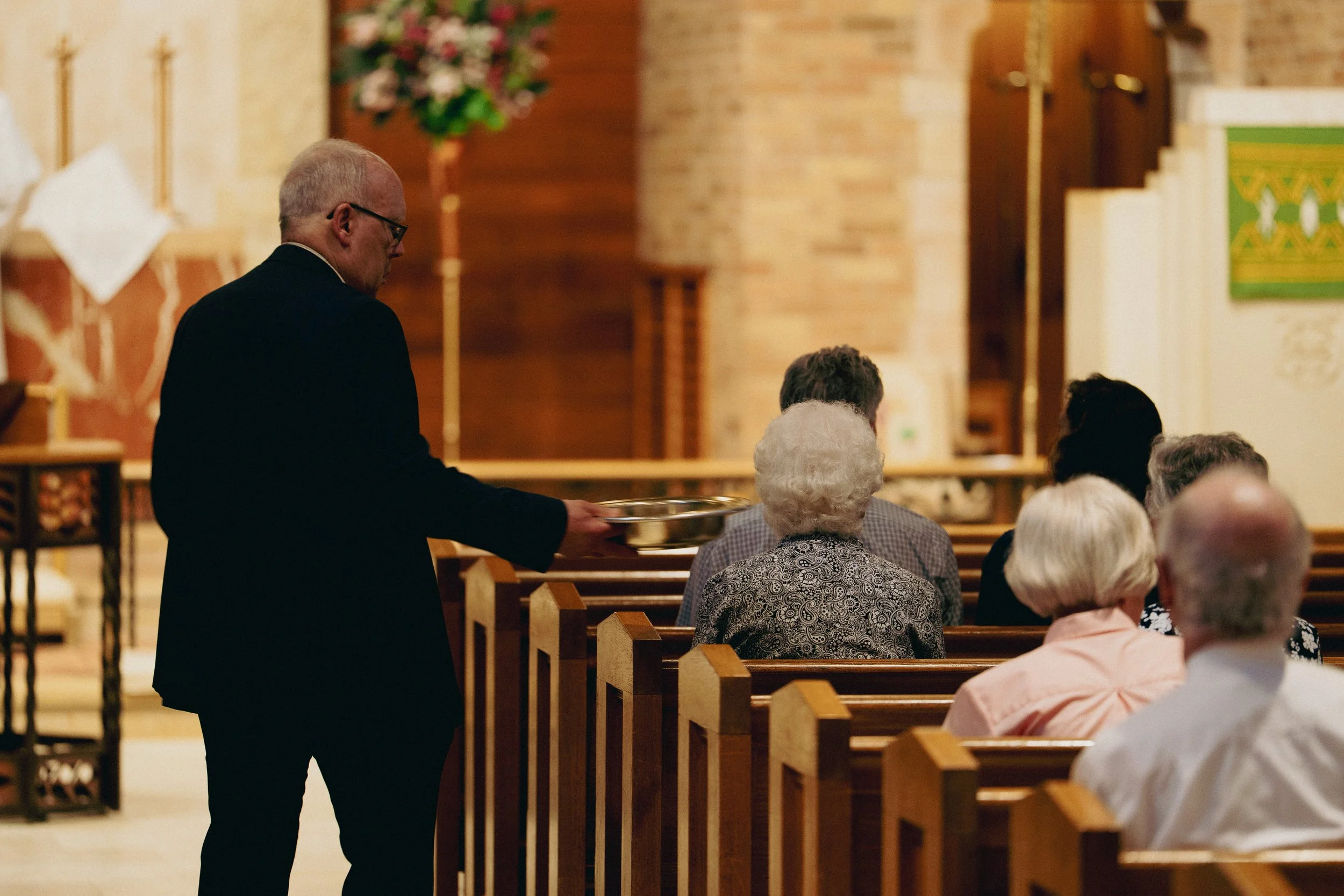 Man showing the offering plate during Divine Service.