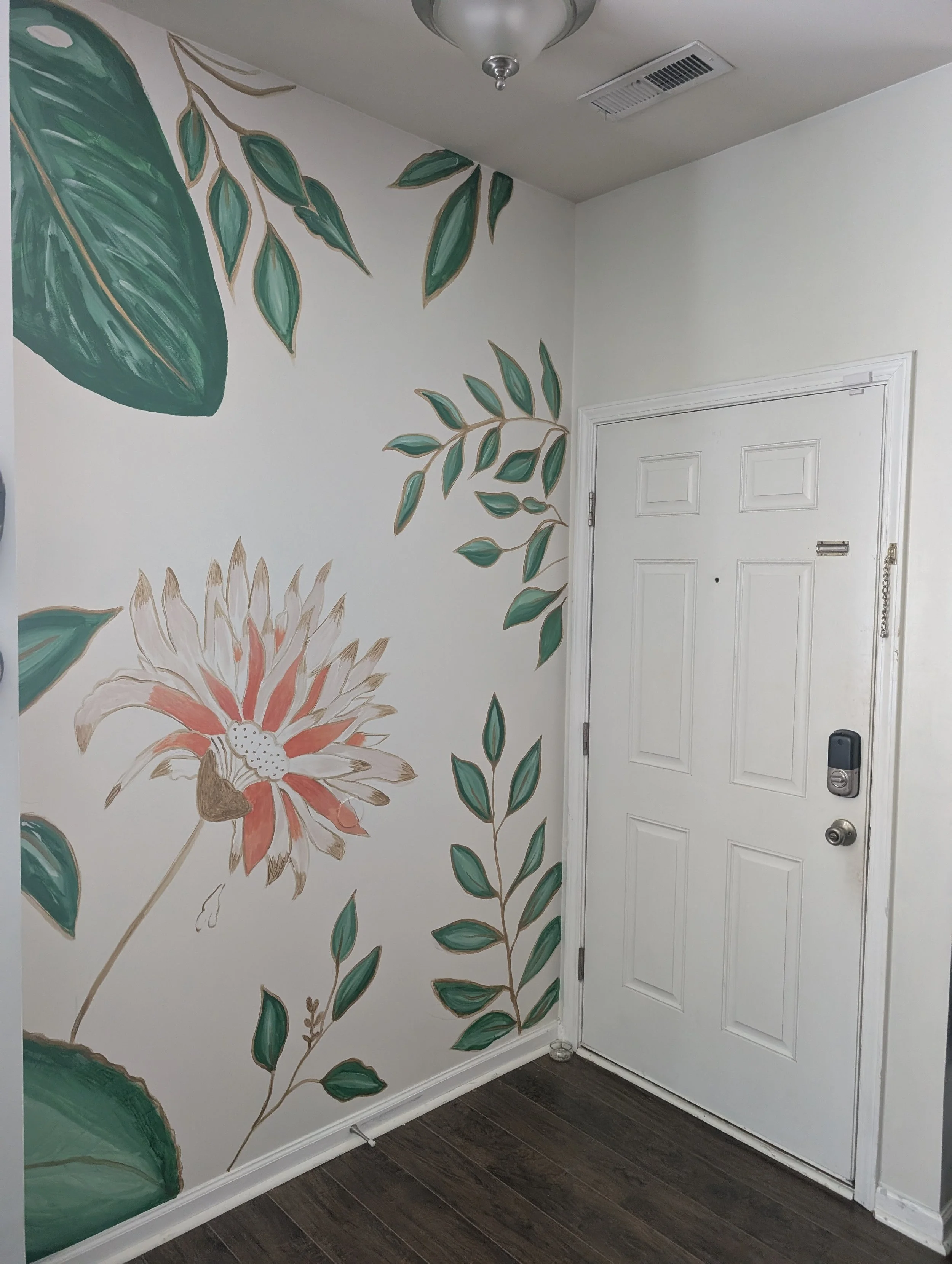 Residential Mural | Entryway
The first thing you see when you walk through the door should set the tone for everything inside.
This entryway botanical mural wraps the walls in oversized tropical leaves, trailing vines, and a single coral bloom with h