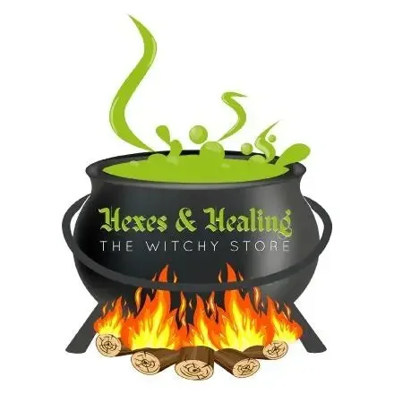 A black cauldron with green potion bubbling inside and smoke escaping, sitting over a fire with logs, labeled 'Herbs & Healing The Witchy Store'.