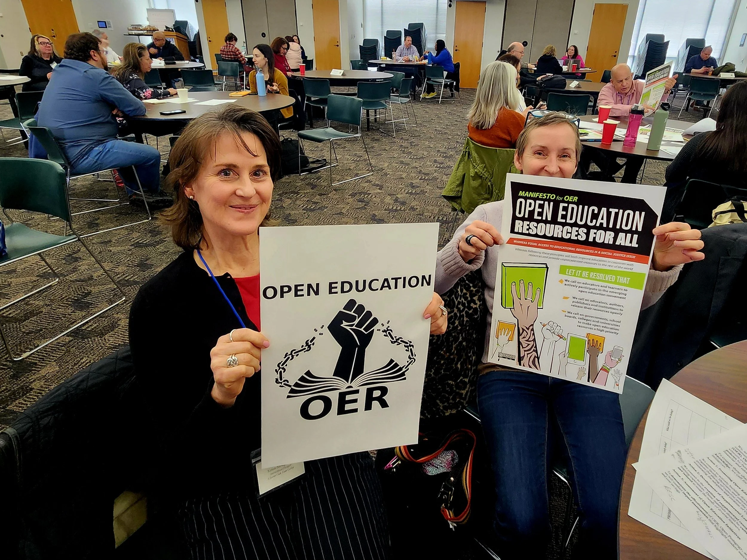 Connecticut OER advocate holding up signs