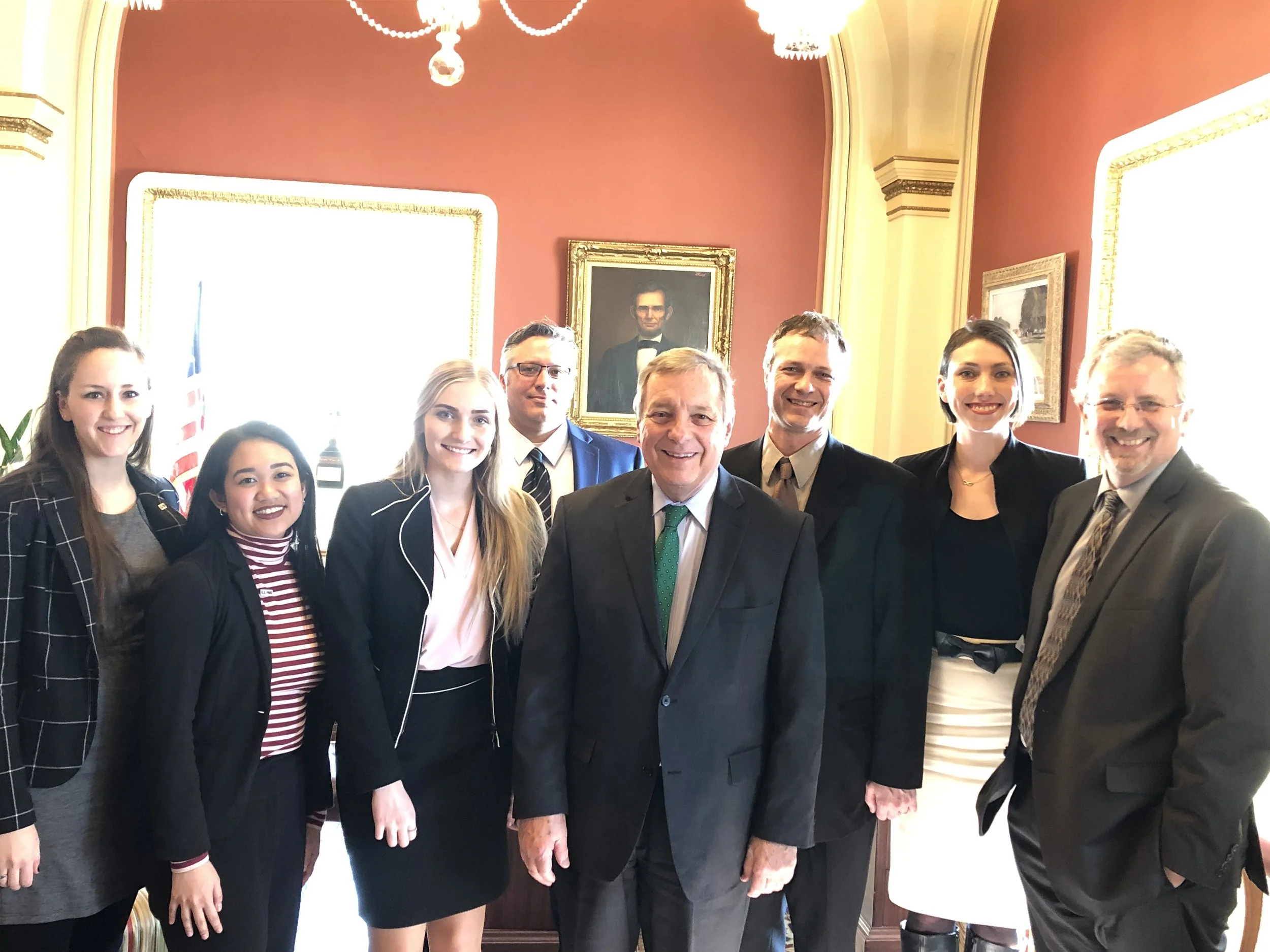 A group of open education advocates stand around Senator Durbin at the U.S. Capitol