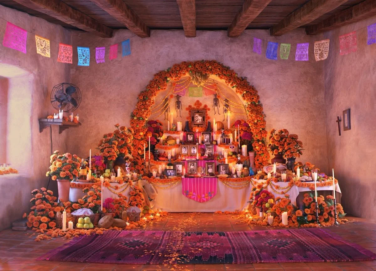 Traditional Día de los Muertos ofrenda with marigolds, candles, and photographs