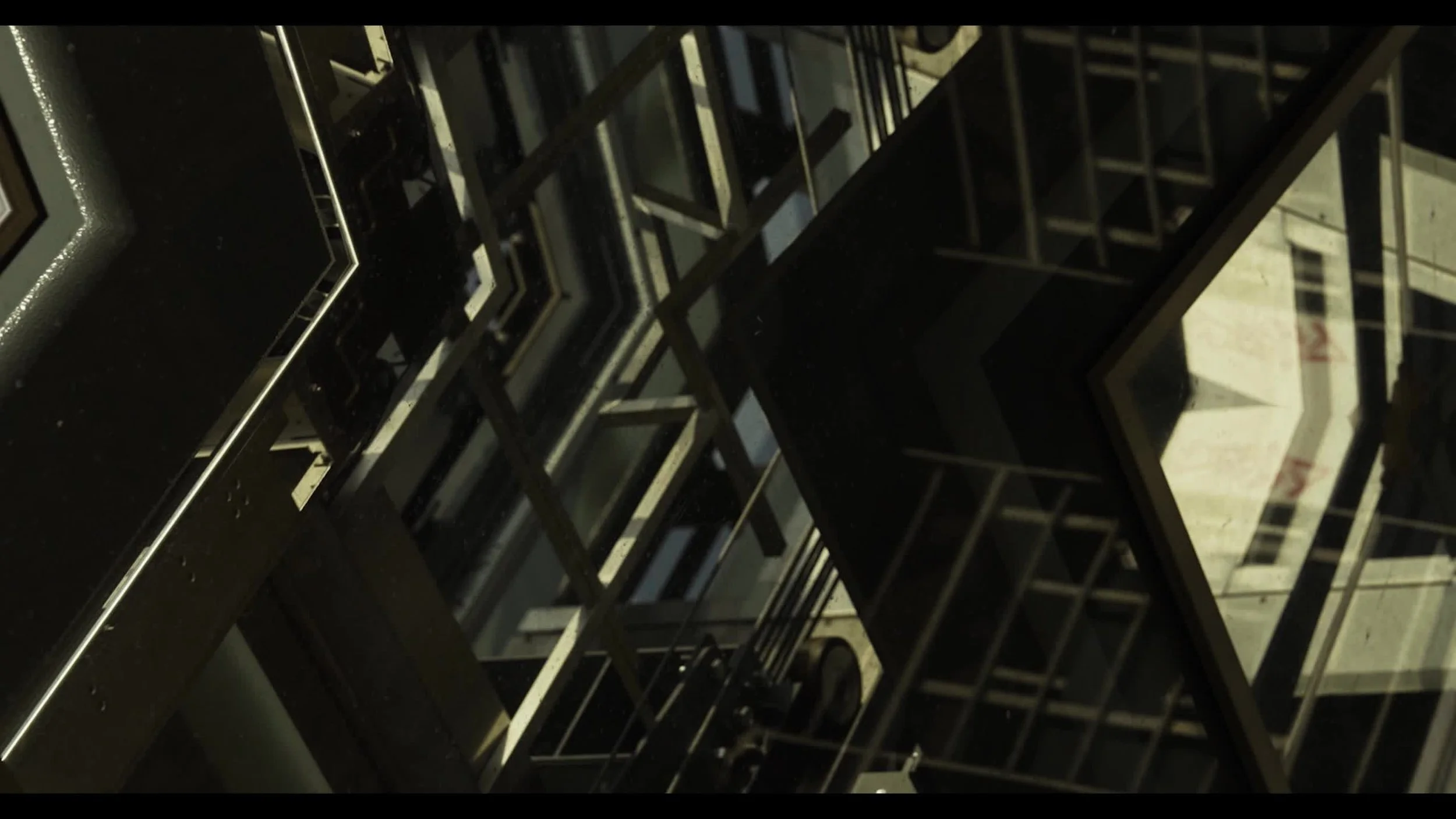 Close-up view of a glass display case with metal shelves, possibly in a store or bakery