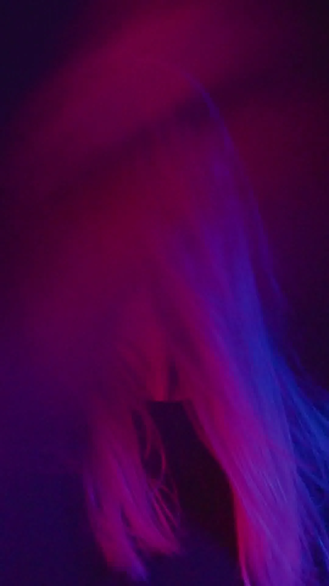 Abstract image with vibrant pink and blue neon light streaks against a dark background.