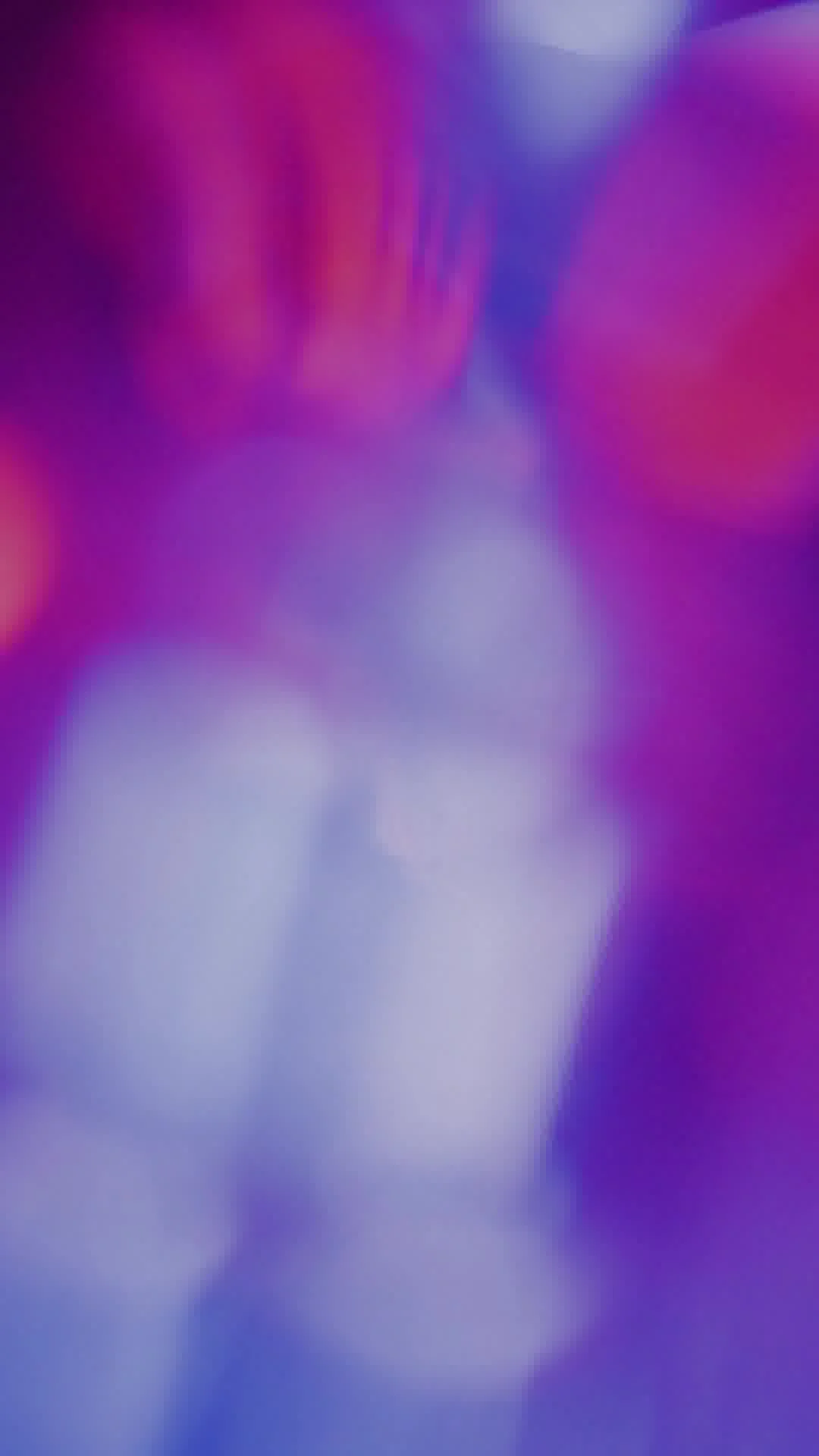 Blurred and colorful image with shades of purple, pink, and blue, no discernible objects.