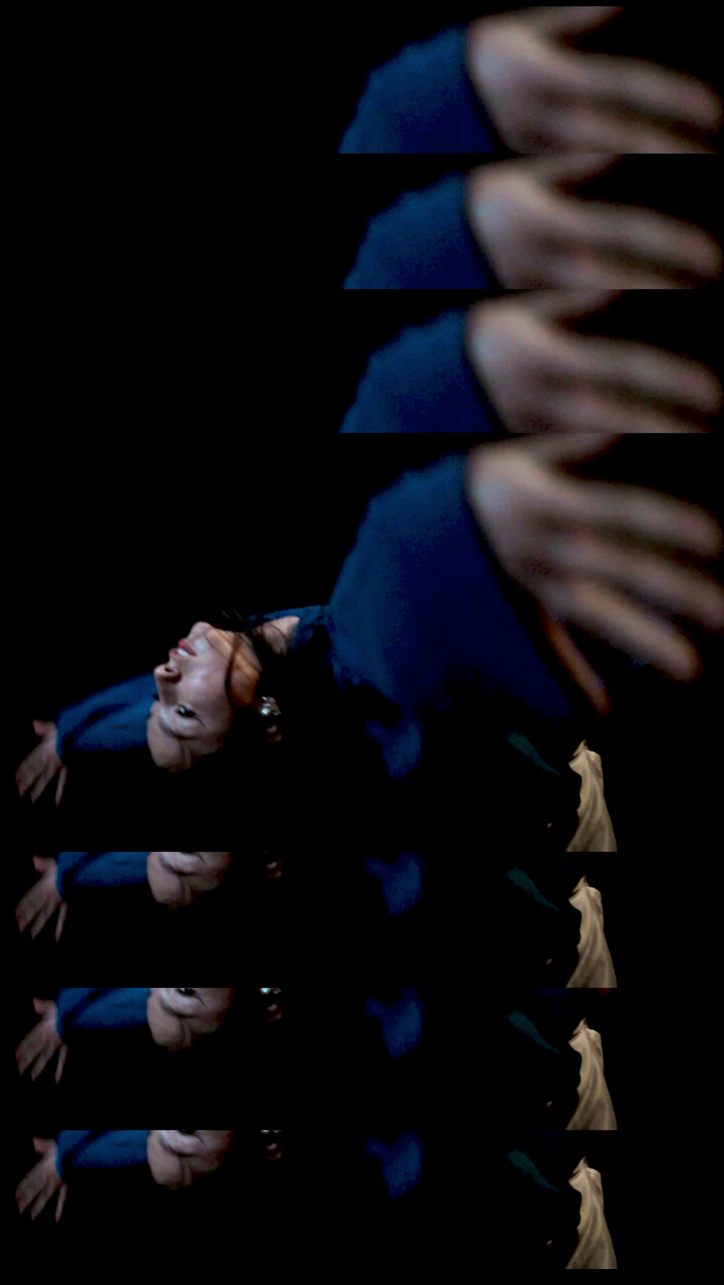 Multiple layered images of a woman with dark hair laughing, wearing a blue top, with a black background.
