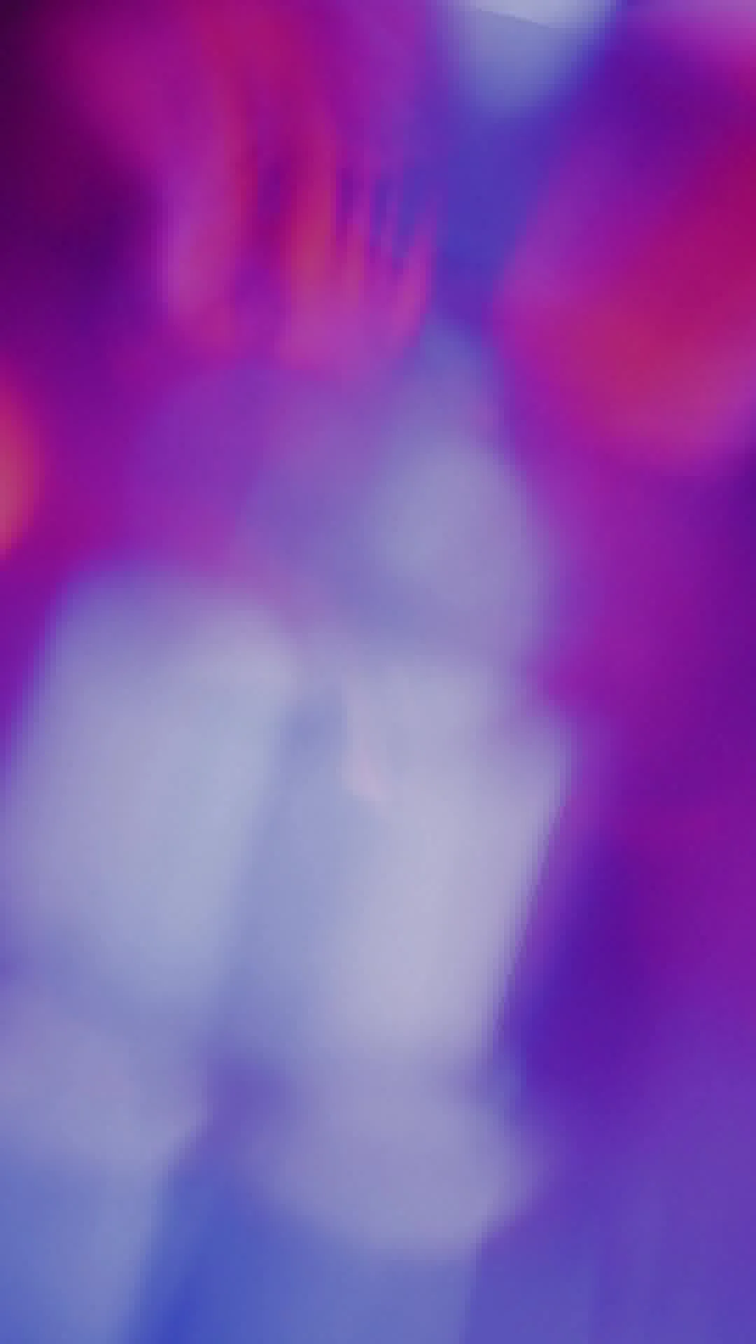 Blurred image with purple and pink hues, abstract colors and shapes.