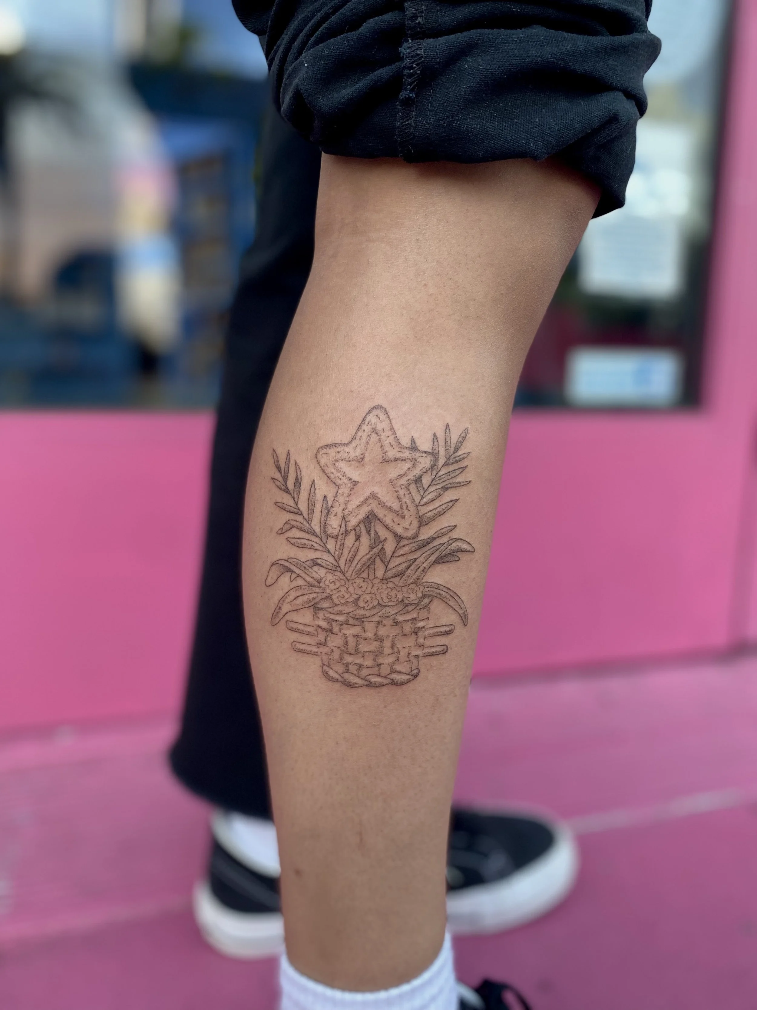 tattoo of a basket, foliage, and star