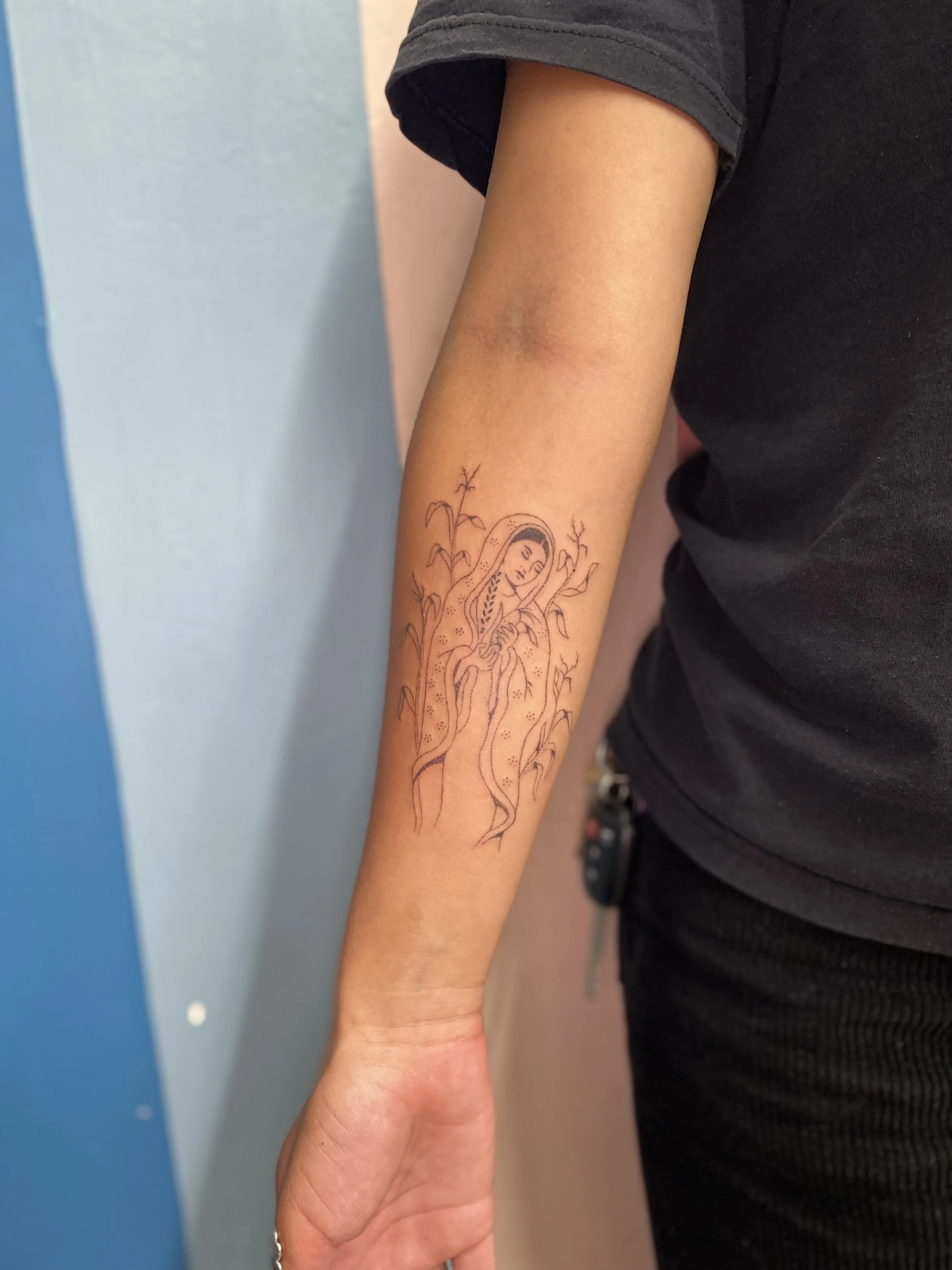 tattoo of a person holding corn