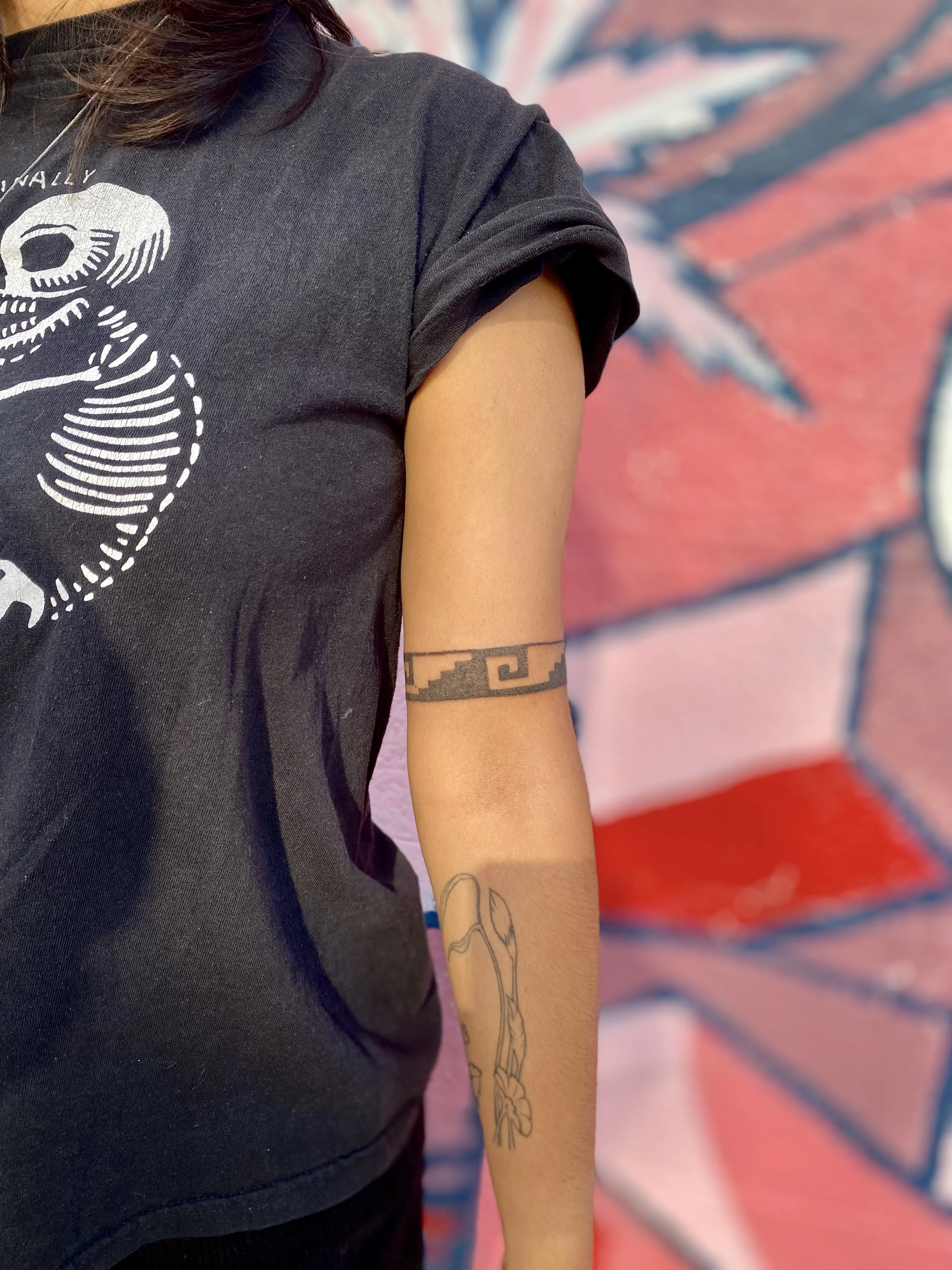 tattoo of a geometric design encircling an arm
