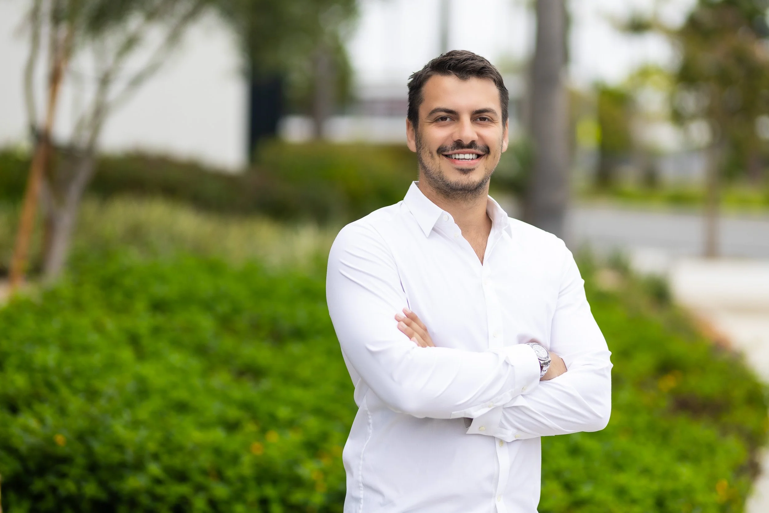 Professional business headshots in front of office building.