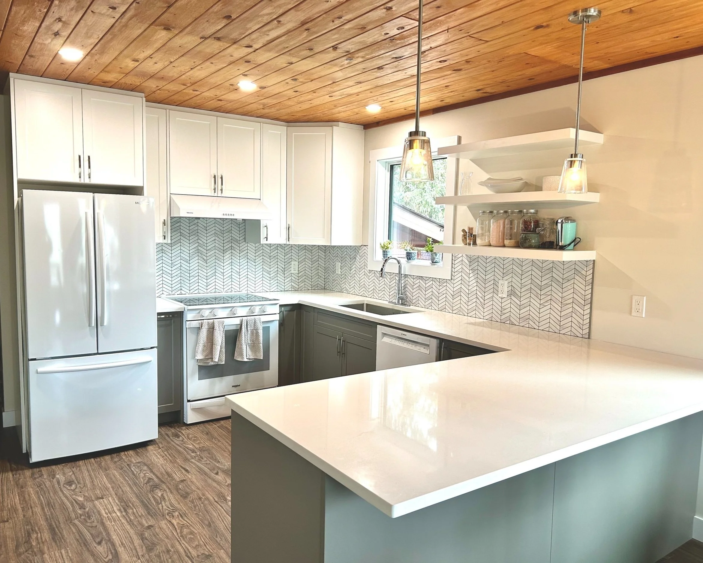 Kitchen installation and new kitchen cabinets. New flooring. White cabinets, quartz countertop, new trim, white appliances. Telkwa home renovations. Telkwa kitchen installation. Telkwa kitchen contractor.