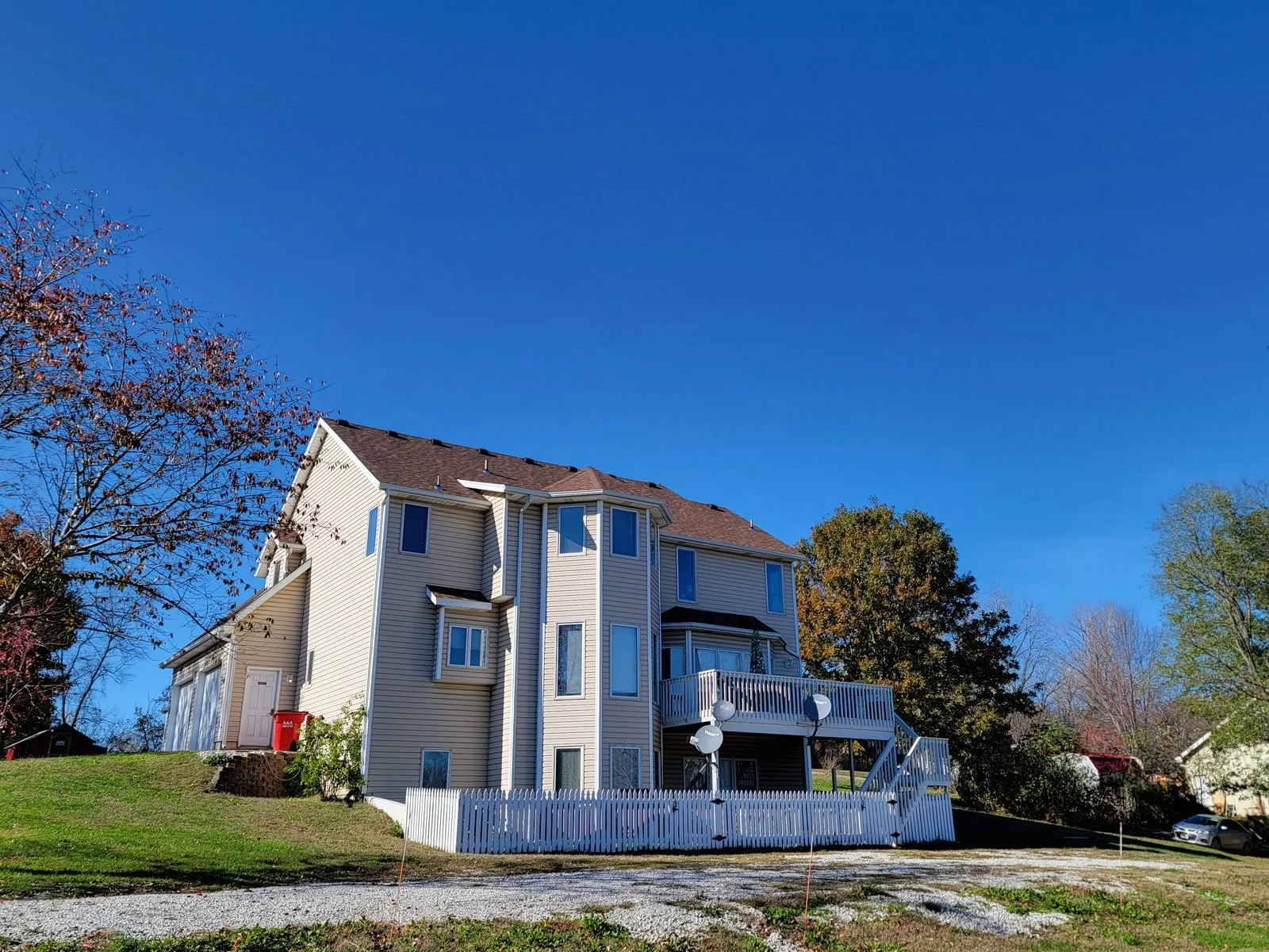 Completed roof on a three-story home with a rear deck