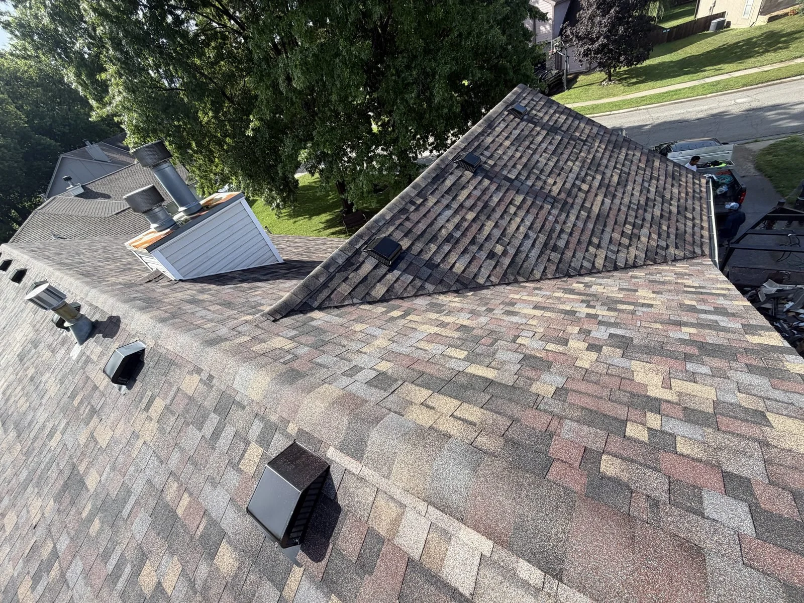 Multi-tone architectural shingles installed around a dormer