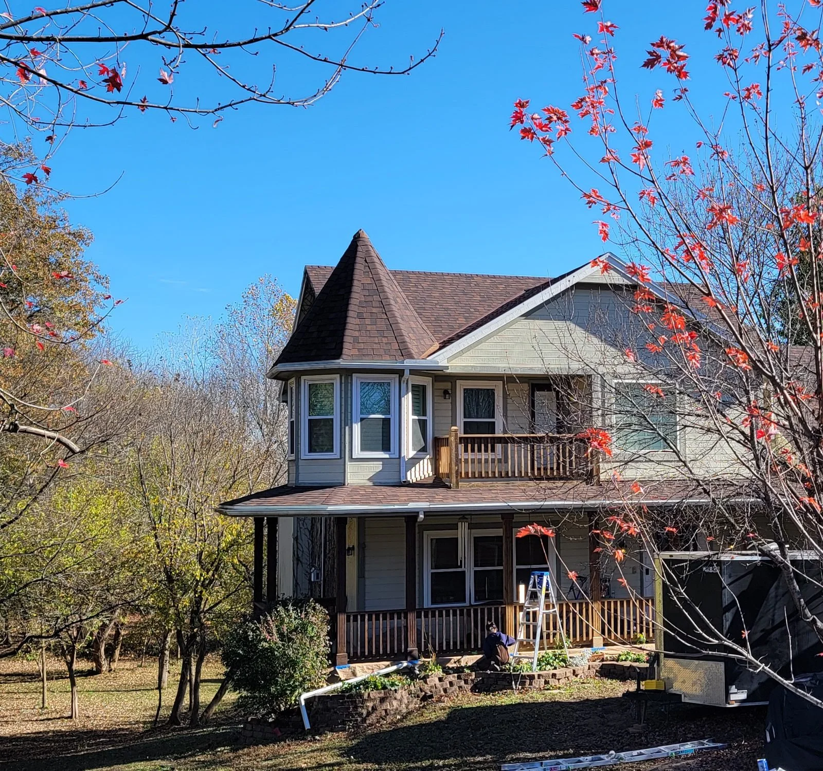Home with a newly installed brown shingle roof in the fall