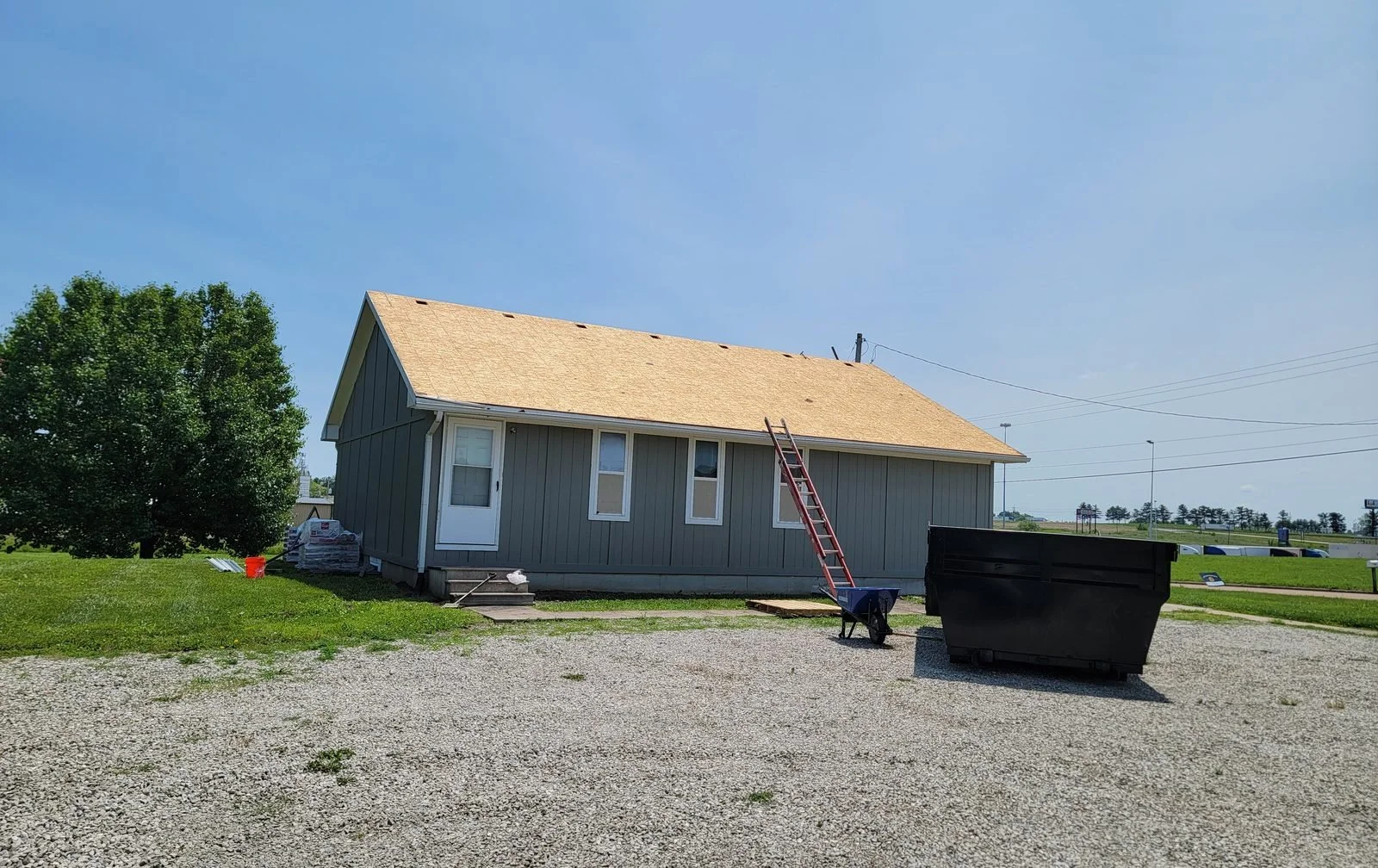 New roof decking installed on a single-story building before roofing