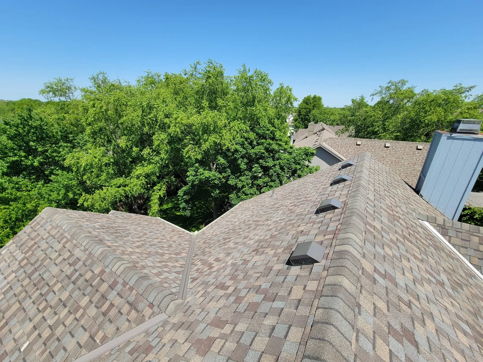 Finished architectural asphalt shingle roof viewed from the ridge