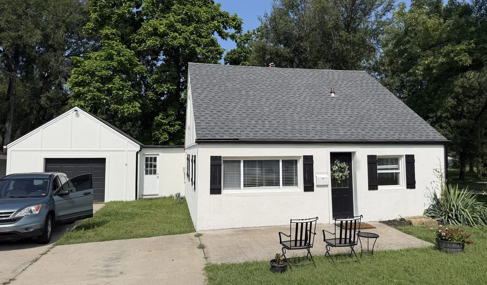 White single-story home with a completed gray asphalt shingle roof