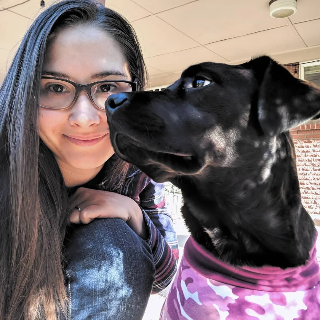 Picture of the owner, Brittney, with a black lab.