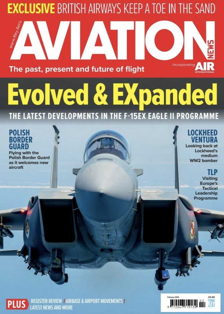 Front view of a fighter jet aircraft in flight on the cover of an aviation magazine.