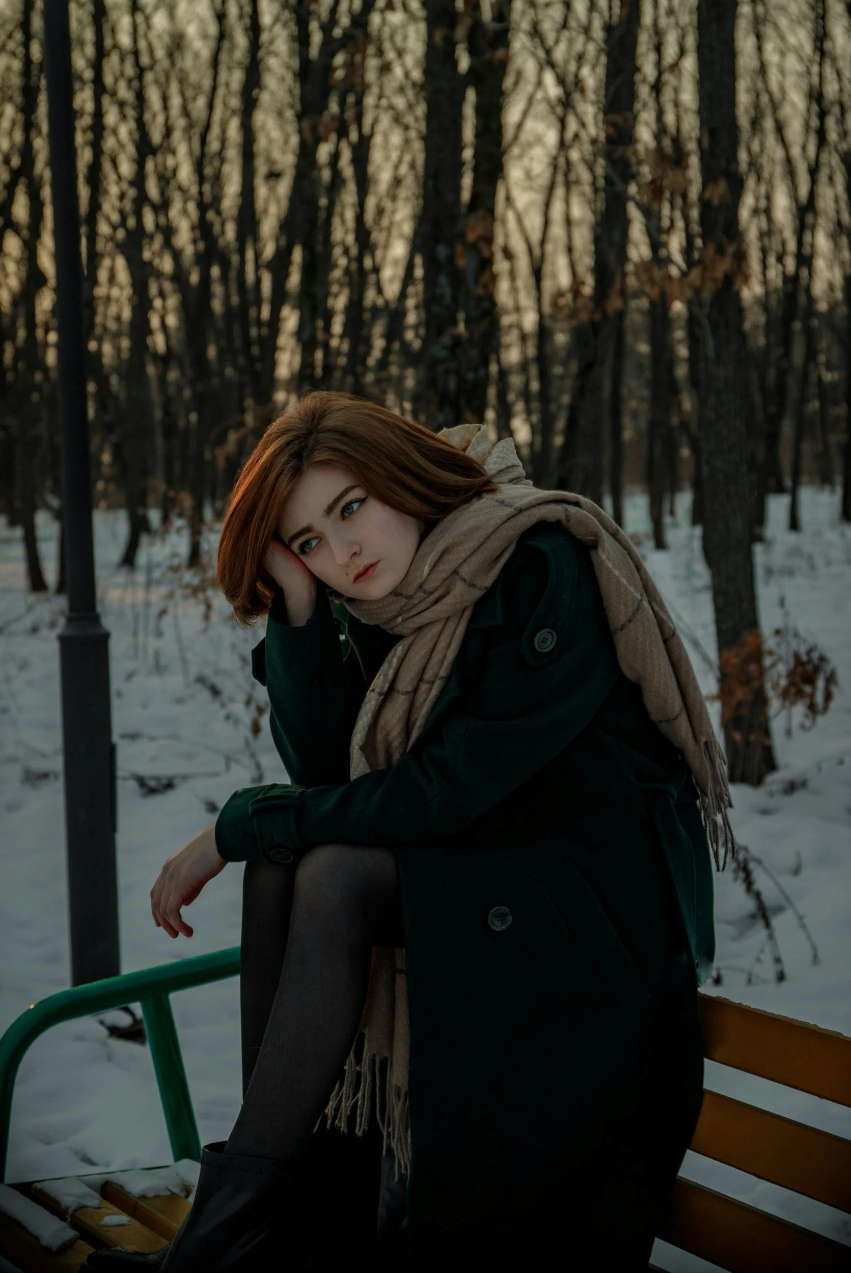 Person sitting outdoors in winter feeling emotionally heavy, reflecting anxiety and depression that often increase during colder months.