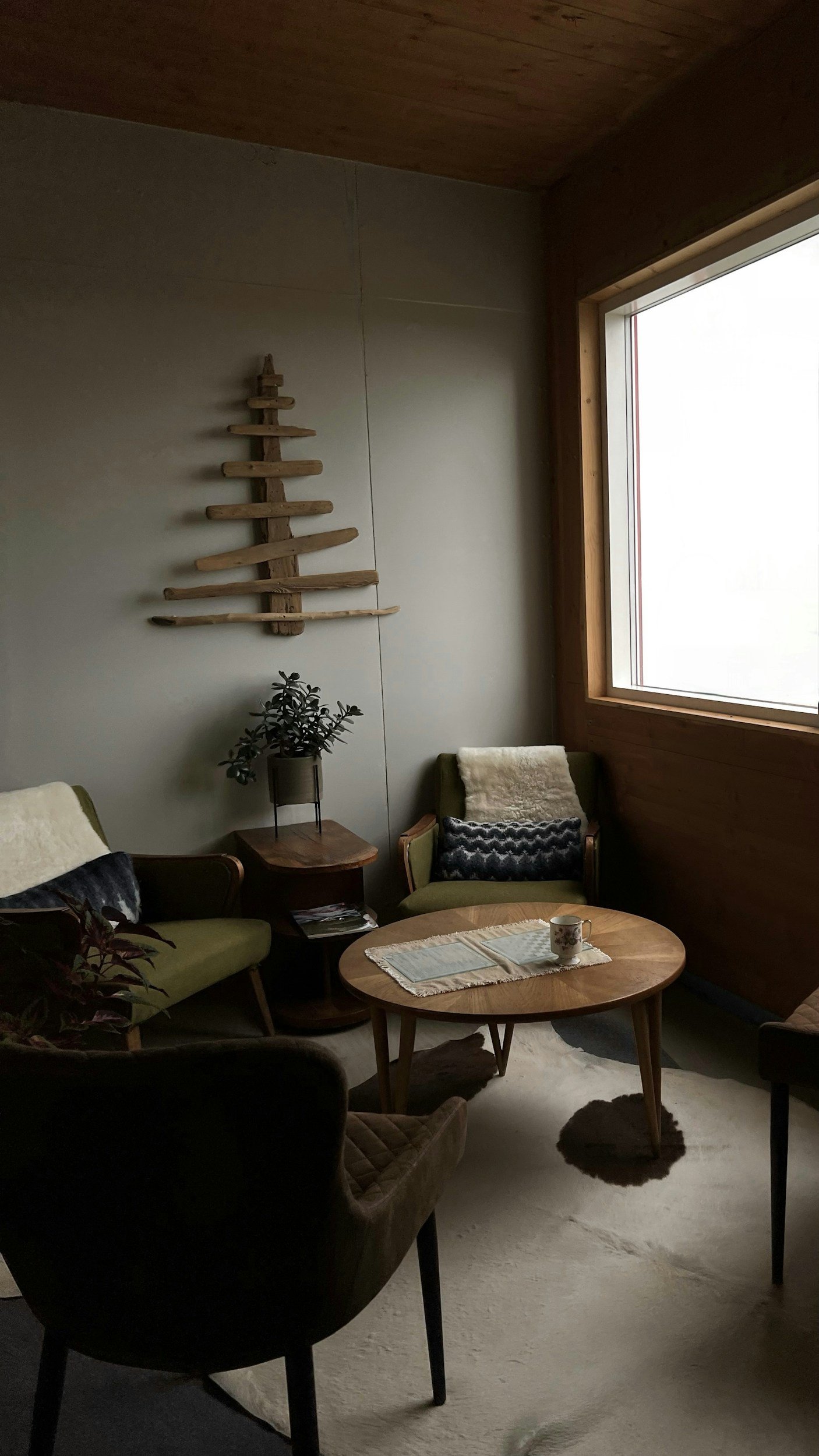 Calm therapy office with comfortable chairs, natural light, and warm details, creating a grounded space for trauma therapy and emotional processing.