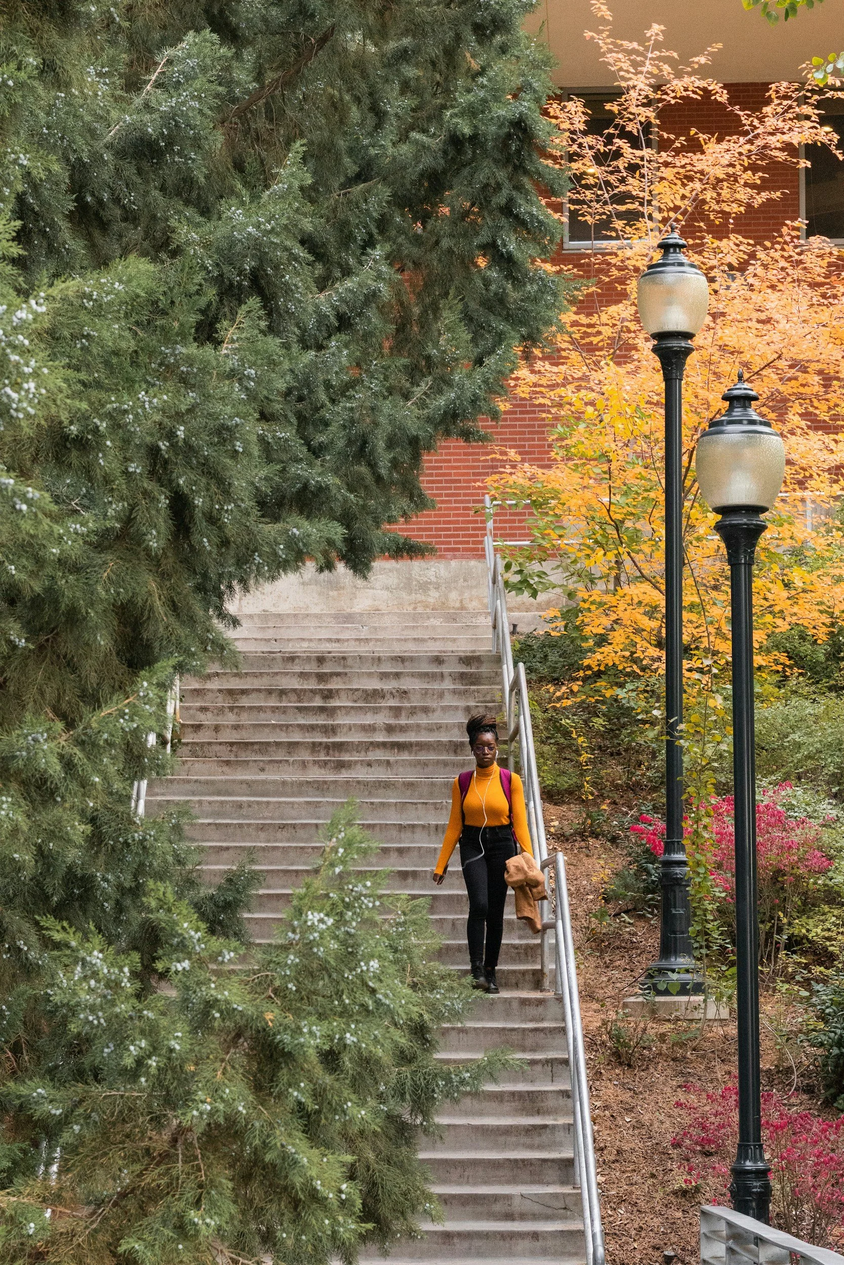 College student walking across a university campus while feeling overwhelmed and burned out.