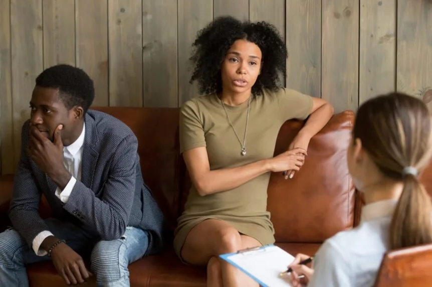 Couple meeting with a therapist during couples therapy in Philadelphia, working through relationship stress after the holidays.