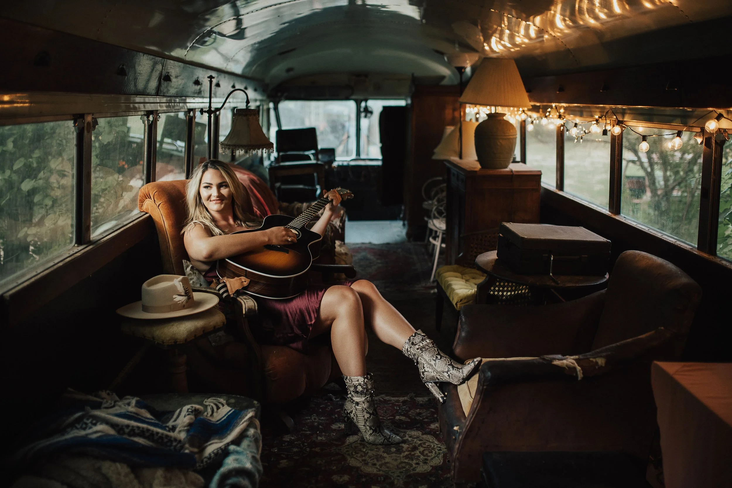 woman holding guitar in van