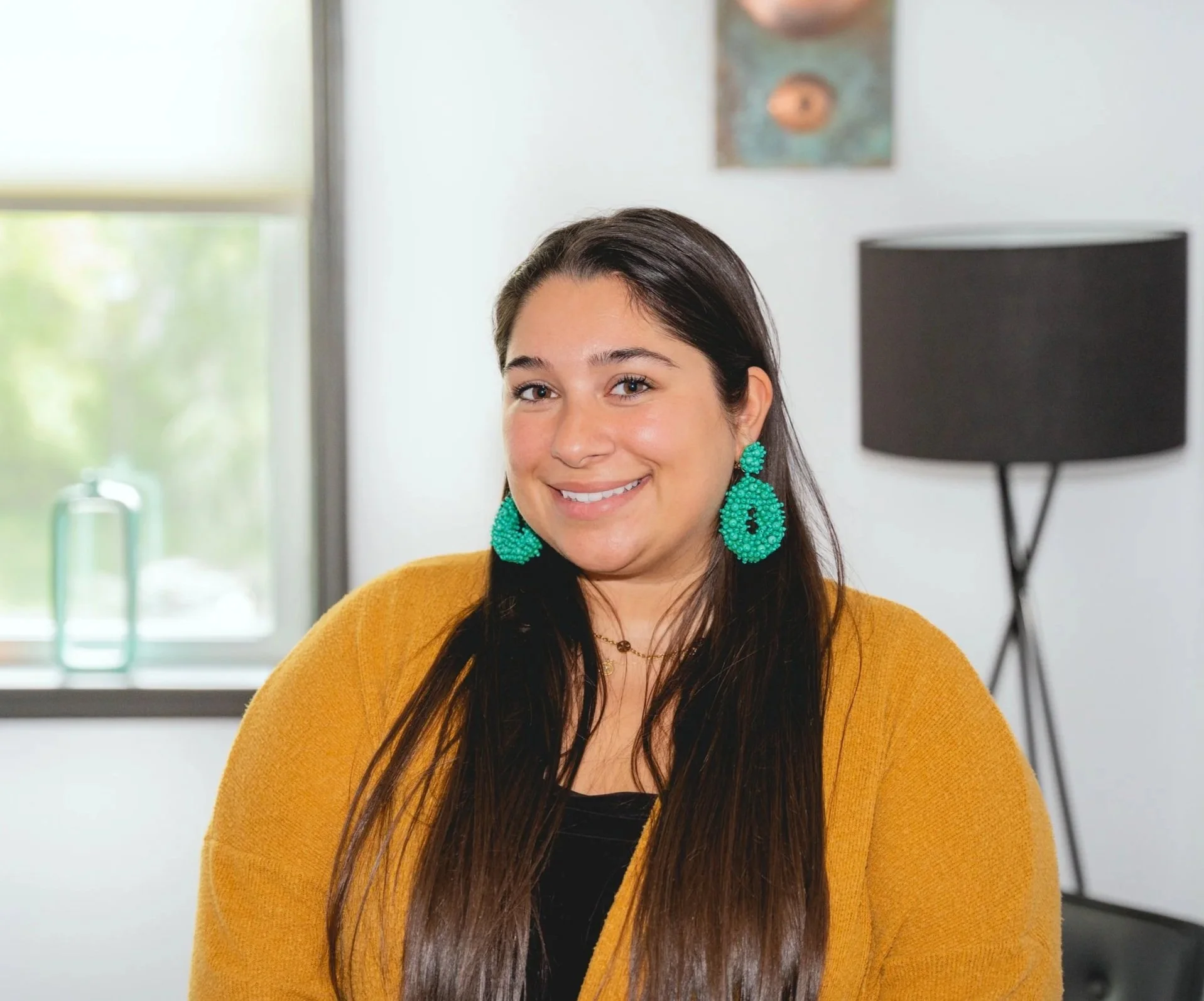 A woman smiles in an office
