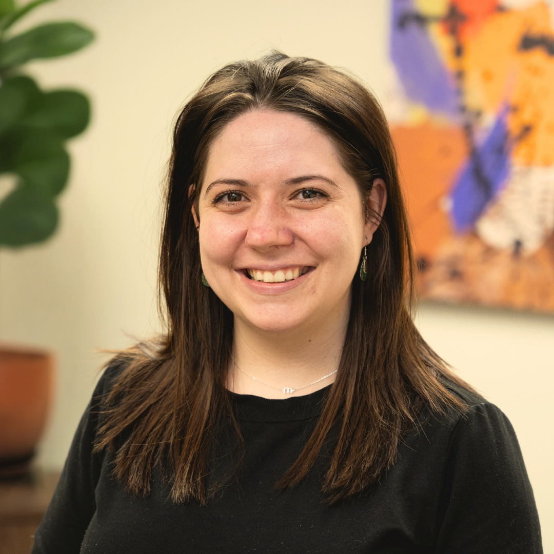 A woman smiles in an office