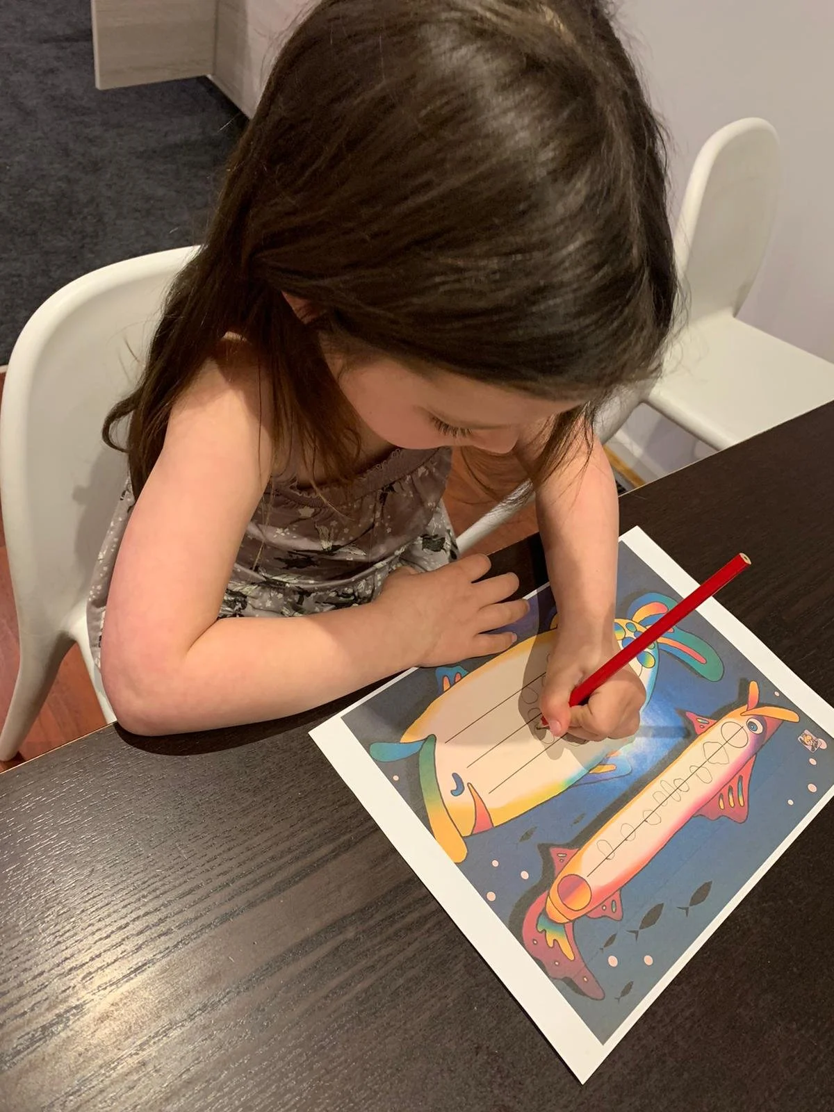 Child drawing during music activity at table