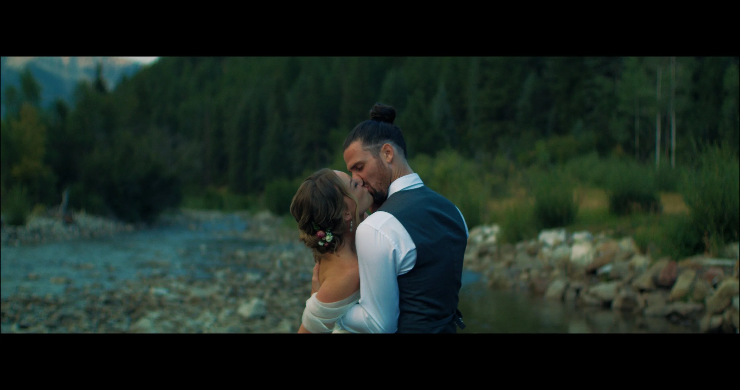 A couple together beside the water
